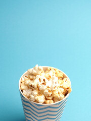 Fresh popcorn on a blue background