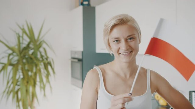 Charming Short Blonde Hair Woman Waving A Small Polish Flag Inside The House - Slow Motion