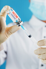 Vaccine ampoule in the hands of a physician researcher.