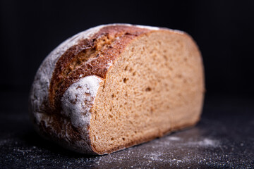 Freshly baked wheat bread, homemade cakes, still life with bread, crisp loaf of bread, still life on a rustic background, rustic style, roll, loaf.