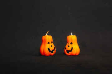 orange pumpkin candles with Jack's face on a black background. preparation for the Halloween holiday