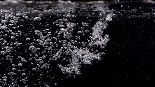 Liquid Bubbles in clean Spa on Black Background Slow Motion