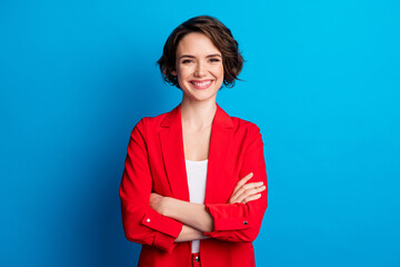 Portrait of attractive content cheerful brown-haired lady folded arms isolated over bright blue...