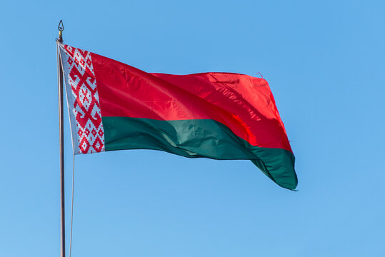 Flag of Belarus waving against blue sky