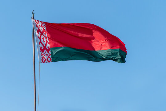Flag of Belarus waving against blue sky