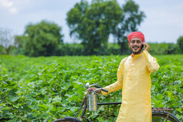 Young indian farmer or labor talking on mobile phone