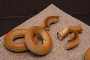 Round golden bagels on wooden background