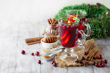 Christmas Hot mulled wine in glasses with orange slices, cranberries.