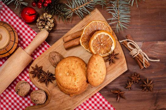 cookies with chocolate on a wooden background with Christmas tree branches and decorations