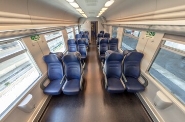 View of the interior of a train with empty seats