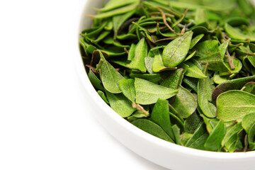 Leafy natural green tea on a white background