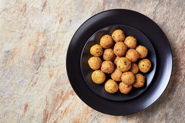 Mediterranean deep-fried falafels on a black plate