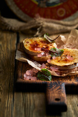 Baked Camembert cheese with toasted bread on wooden board