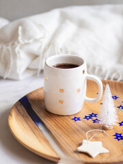 Mug with coffee, Christmas tree on a tray