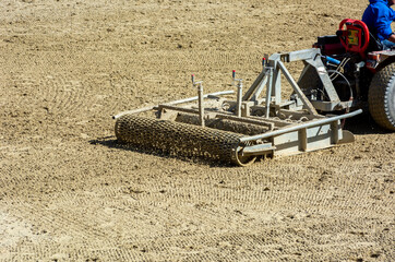 Close up of a tractor preparing the Field before an Equestrian competition in Italy