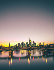 Fototapeta na wymiar Germany Frankfurt am Main. River view in the evening or morning with great colors in the sky and backlit long exposure