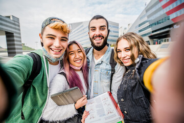 Group of happy students taking a selfie at school - Young people with face mask having fun outdoor...