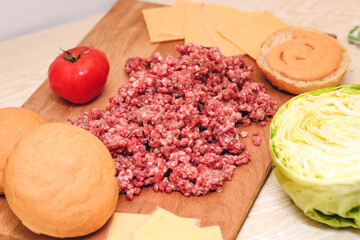 Fresh minced meat for making a burger at home. Ingredients for a homemade cheeseburger.