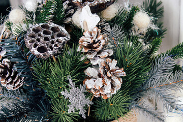 New Year's composition of dried lotus flowers, cones and spruce branches. DIY bouquet for Christmas