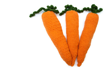 Knitted carrot on a white background, Orange carrot, toy carrot, easter carrot