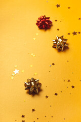 Christmas and New Year background on gold with stars, bows and sparkles. Copy space
