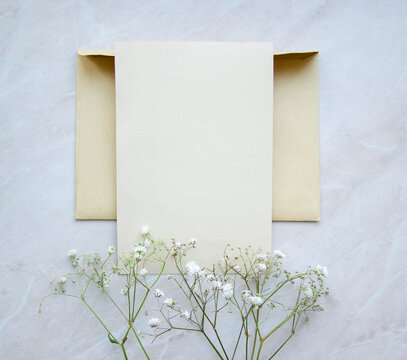 Greeting, post card, invitation card photo mock up on marble background with the decor.