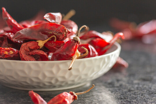 Dried red chili or chilli cayenne pepper on black marble background, close up