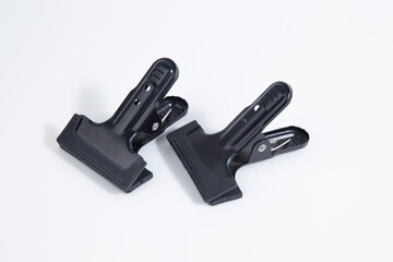 Clothespins are black on a white background.A tool for photos.