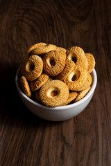 Ring Coconut biscuits served on a bowl. Brazilian little donut. Seletive focus in a top view
