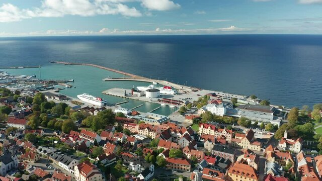 Harbour port aerial drone footage, flying above moored ferrys in Visby, Gotland