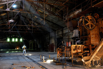 Male urban explorer in an abandoned brickmaking factory