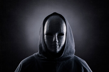 Portrait of a scary figure in hooded cloak