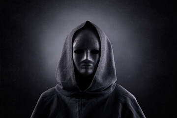 Fototapeta na wymiar Portrait of a scary figure in hooded cloak