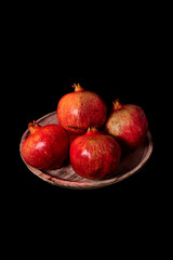 Pomegranates on wooden plate