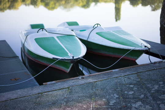 Two paddle boats are parked and moored at the end of the season