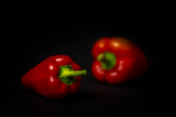 red bell peppers on black background