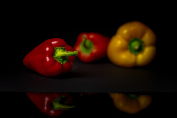 red and yellow peppers on black background