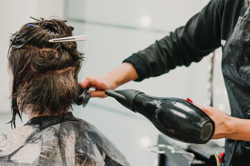 Hairdresser Using Dryer on Woman Wet Hair in Salon. Short Hair. Hairstyle