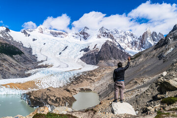 Young man, trekking tourist goes to Fitz Roy, De Los Tres Mirador view point in the mountains of