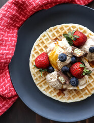Dessert waffle with fresh strawberries and Blueberries, ice cream and chocolate 