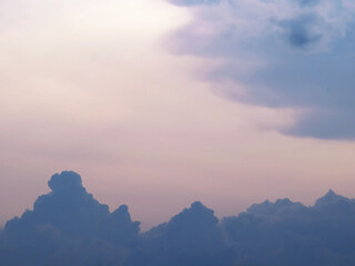 Stormy clouds are moving in at sunset revealing the purple clouds and the pink sky