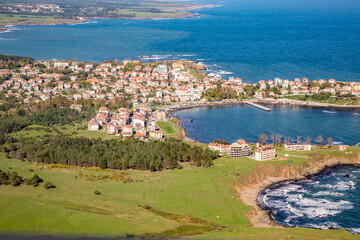 Fototapeta na wymiar Town of Ahtopol from high above. Tandem motor paragliding over Black Sea shores near town of Ahtopol. Sunny autumn day, scenery colors and amazing landscapes and seascapes, Bulgaria
