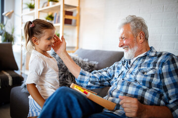 Grandparents playing and having fun with their granddaughter