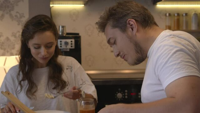 Young attractive couple having appetizing dinner at home. People enjoy home food lifestyle concept. lovely couple enjoying dinner indoor