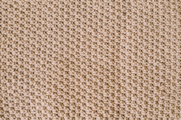 Knitted texture background. Knitting pattern of wool. Knitting. Texture of woolen fabric for wallpaper and abstract background.