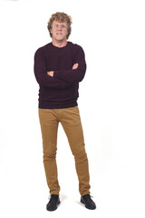 Fototapeta premium full portrait of a man, front view with curly hair and white background,arms crossed,