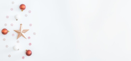 Flat lay border with christmas balls, stars and snowflakes on a white background