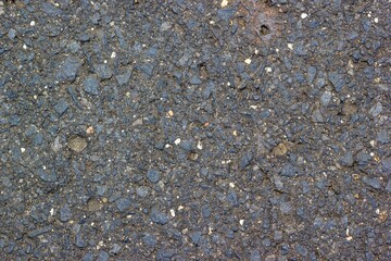 Close up of the asphalt of a German side street with its different materials visible