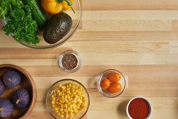 High angle view of fresh ingredients in bowls on the table for preparing food
