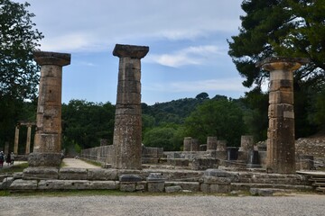 Fototapeta na wymiar Temple of Hera Ancient Olympia on the western side of Peloponnese, is most famous as the venue of the ancient Olympic Games. The Olympic flame is lit here